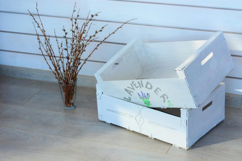Rustic decor scene with willow branches in vase next to a labeled lavender box.