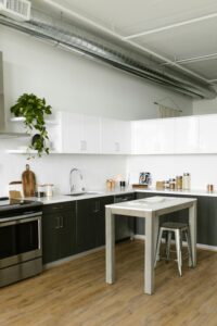 A stylish, minimalistic kitchen featuring industrial design elements and modern furnishings.